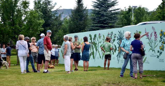 Visitors viewing Wallflowers mural. 